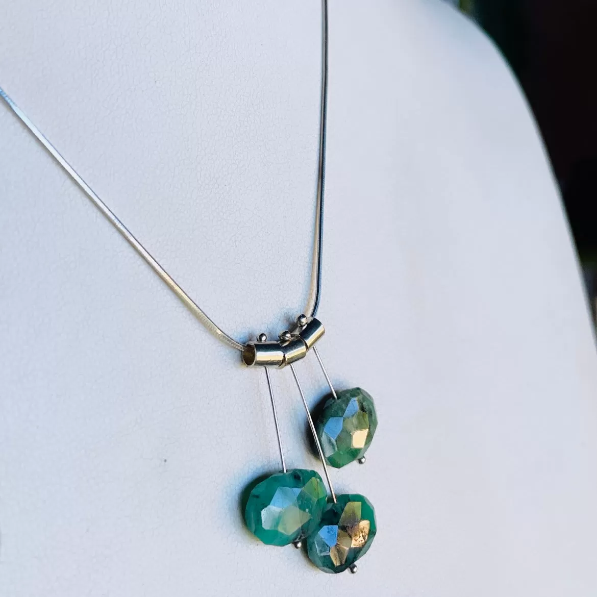 3 petal pivot emeralds necklace